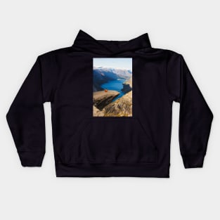 Man sitting on Trolltunga rock meditating Kids Hoodie